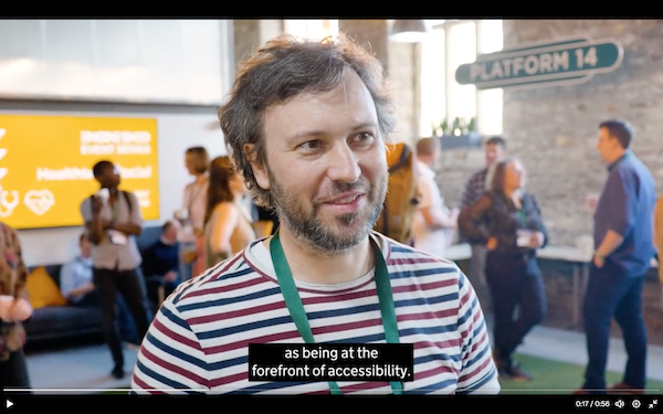 Andrew Hick, a white beardy man in a stripy T-shirt, talking about accessibility