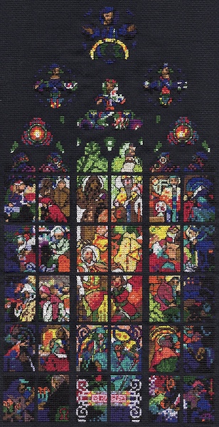 A stitched gothic window with various Jesus-y and saintly things happening across 42 panels (there are quite a few haloes and people looking authoritative). Radiating from the centre, the colours are mainly yellow and orange, whereas the outside is more dark blue.