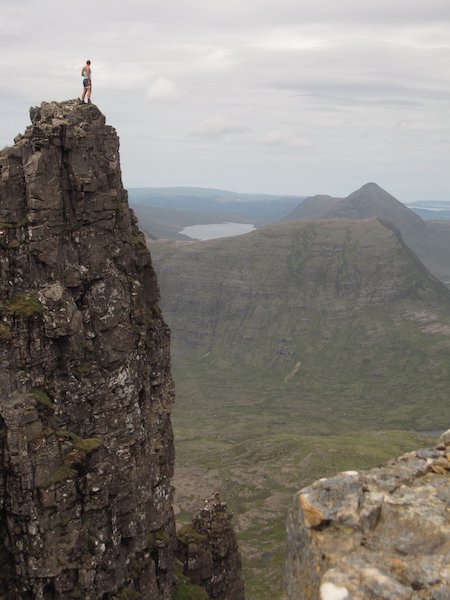 Woman standing on a high rocky peak