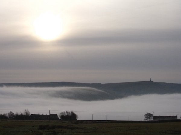 Monument across a misty valley