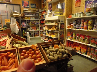 Tiny greengrocer model with thumb for comparison