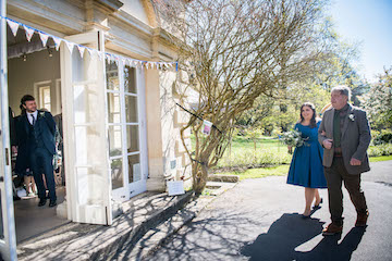 Victoria and her dad approaching the venue with Andrew peering out