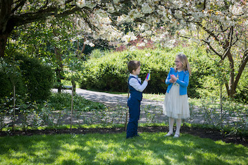 Best man and bridesmaid playing on the lawn