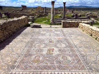 Figures on a mosaic in the sun